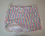 Handmade bikini bottom with colorful sequin stripes on white fabric, laid flat