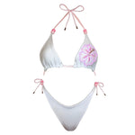 White reversible bikini set with pink beaded flower detail and adjustable ties