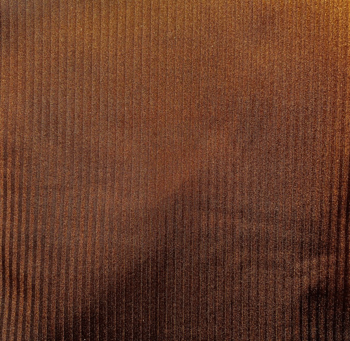 Shimmering brown ribbed swimwear fabric texture, close-up, sustainable bikini material