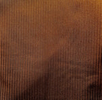 Shimmering brown ribbed swimwear fabric texture, close-up, sustainable bikini material