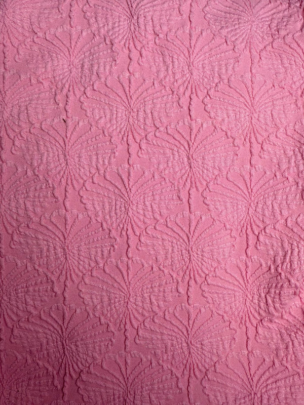 Pink textured fabric with embossed floral pattern, ideal for handmade swimwear, close-up view