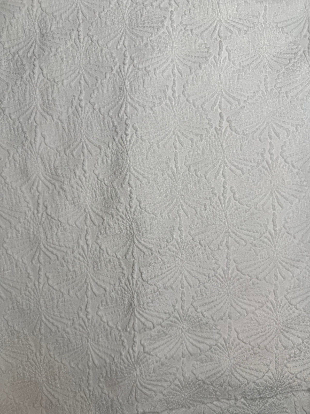 White textured fabric with subtle leaf pattern, ideal for handmade swimwear and bikinis