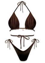 Brown handmade triangle bikini set with tie strings and small charm detail, flat lay.