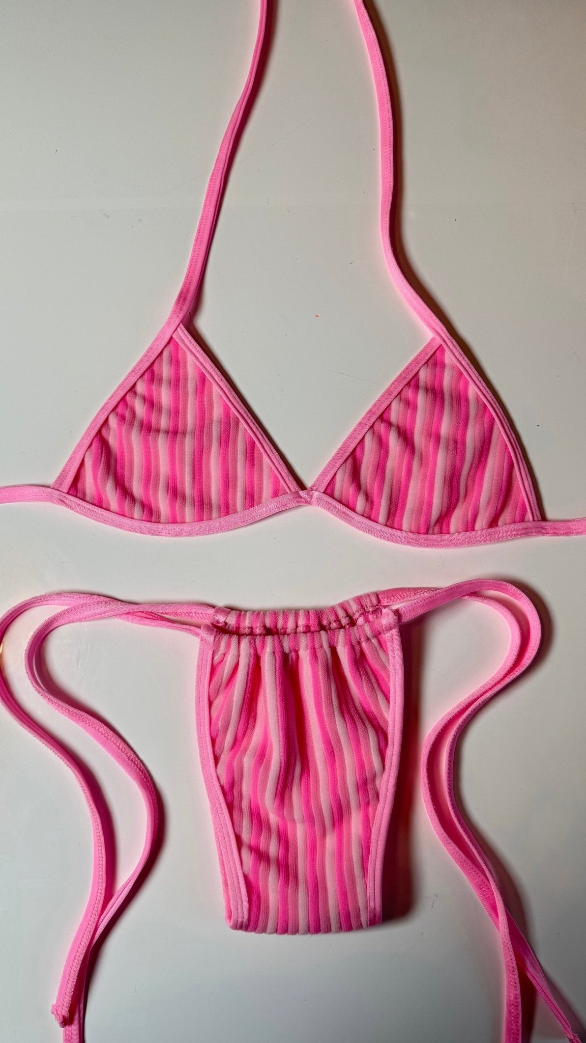 Handmade pink striped reversible bikini set with triangle top and ruched bottoms on white background