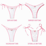 Four styles of white bikini bottoms with pink trim and rose accents: Capri, Sorrento, Valencia, Seychelles.