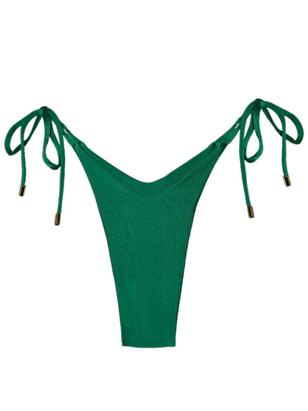 Emerald green bikini bottom with side tie strings and gold accents, swimwear flat lay