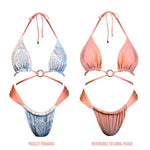 Reversible bikini set with blue paisley print on one side and solid coral peach on the other.