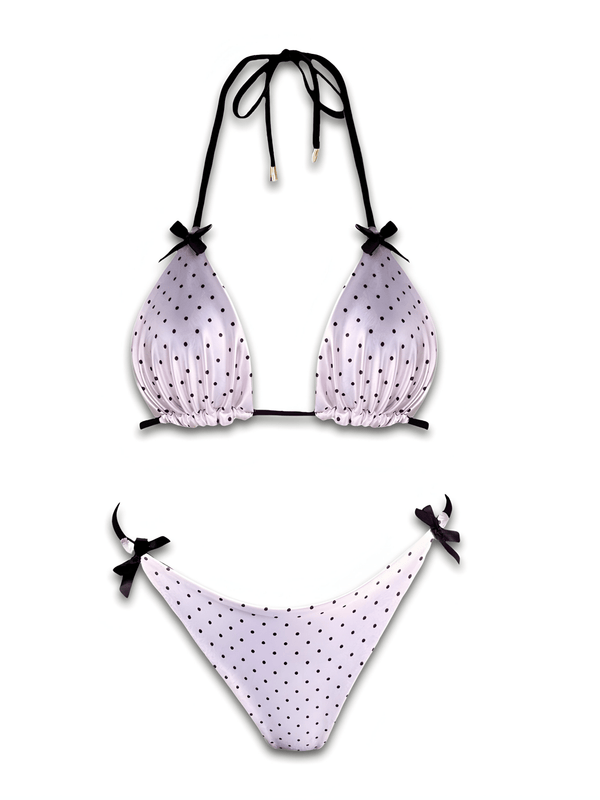 White polka dot reversible bikini set with black tie straps on white background