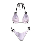 White polka dot reversible bikini set with black tie straps on white background